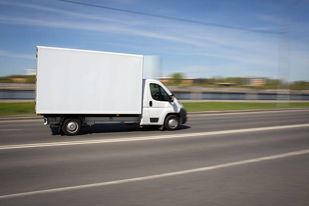 istock White Delivery Van Speeding on street 477470382