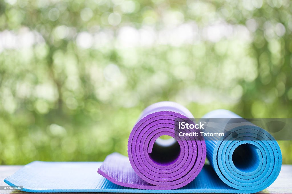 yoga mats in a garden yoga mats on the table in a garden Exercise Mat Stock Photo