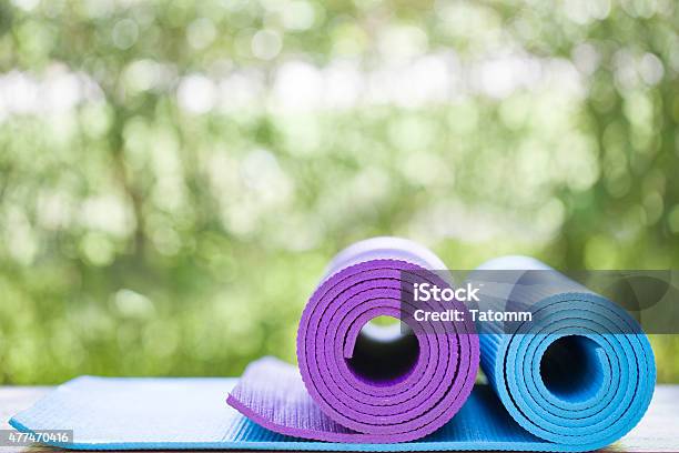 Yoga Mats In A Garden Stock Photo - Download Image Now - Exercise Mat, 2015, Blue