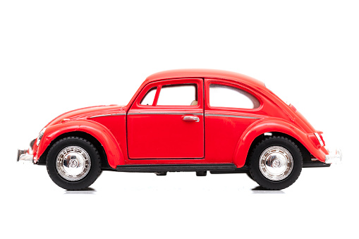 Izmir, Turkey - May 6, 2015: Red Vintage toy Volkswagen car close up image on isolated white background.