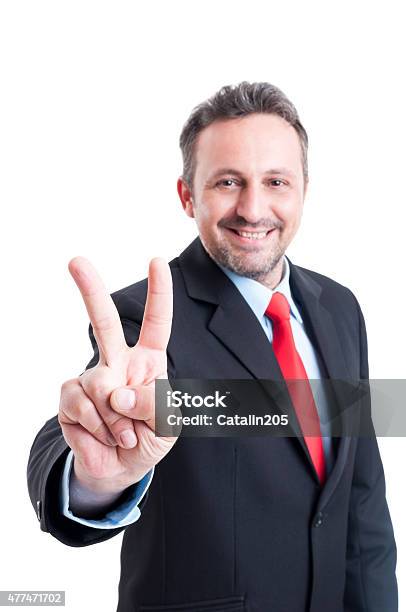 Business Man Showing Victory Sign Or Gesture Stock Photo - Download Image Now - 2015, Adult, Adults Only