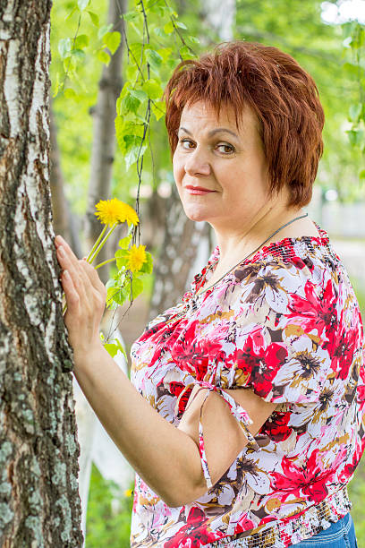 istock Woman with dandelions 477475056