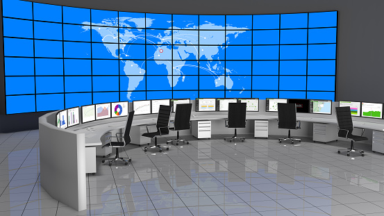 Security Operations Center containing computers desks and a large screen containing the world map.