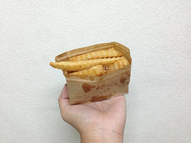 istock Hand holding French fries 477475970