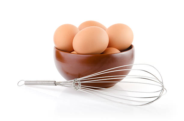 istock Brown Eggs in a bowl with whisk 477476752