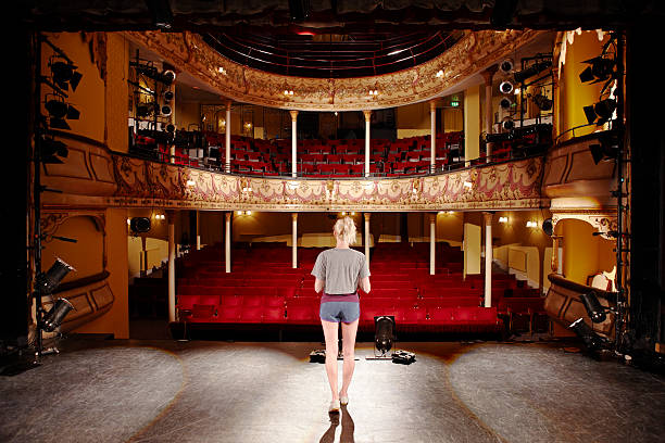 istock Rear View Of Blond Woman On Stage 477478251