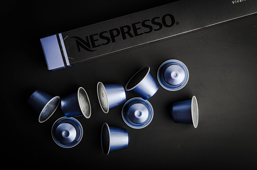 Leonding, Austria - June 15, 2015: Nespresso Vivalto Lungo coffee capsules on a modern black table. Nespresso is an operating unit of the Nestle Group based in Switzerland. 