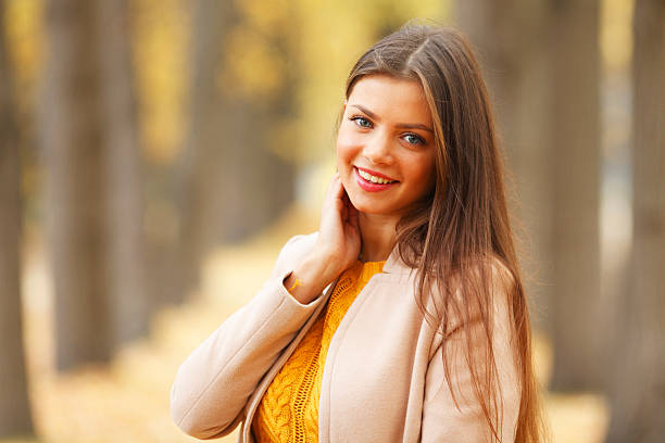 istock Woman in autumn park 477479118