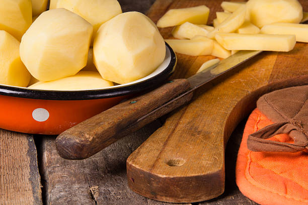 istock Raw potatoes in a vintage enamel bowl 477480042