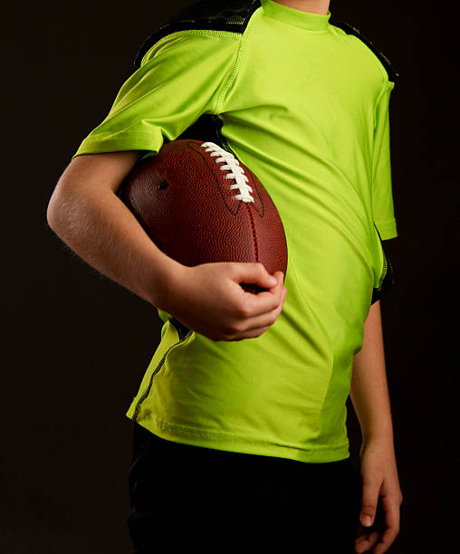 istock Young Boy Holding a Football 477484897