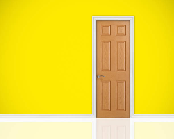 istock Closed wood door on yellow wall 477485046