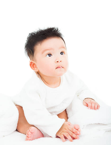 istock cute newborn infant baby sitting and looking 477485595