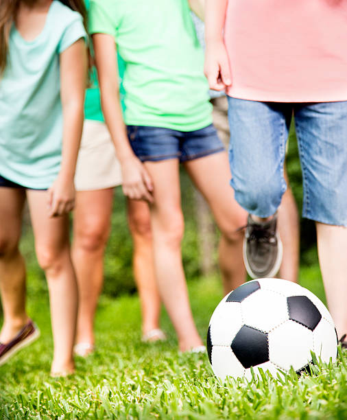istock Family outdoors in summer playing soccer game. Park. 477486062