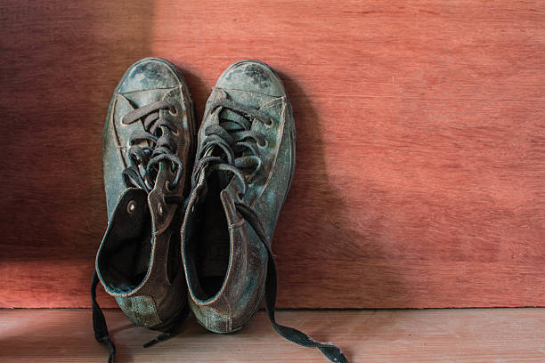 istock sneakers at wooden wall. 477486214