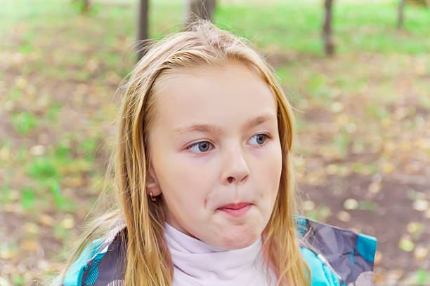 Low angle view of a child looking away in the park
