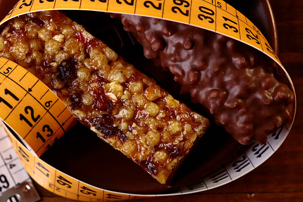 Tasty chocolate bars and peanut brittle with a measuring tape