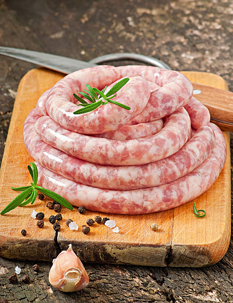 istock Fresh raw sausage on the old wooden background 477495783
