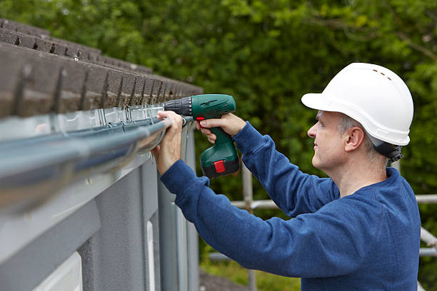 istock Workman Replacing Guttering On Exterior Of House 477497304