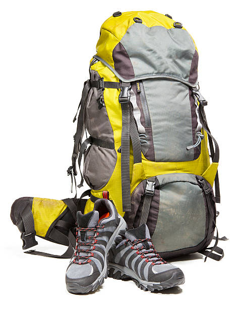 istock Hiking shoes and packed backpack on white background 477497488