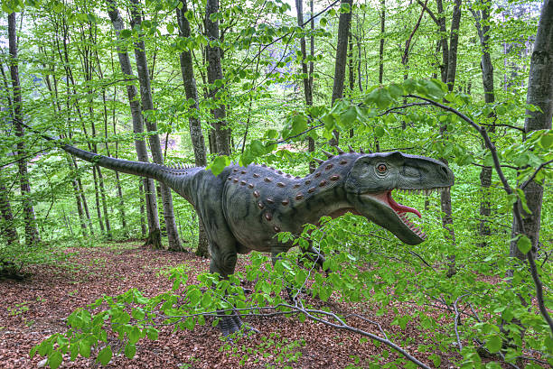 istock The lost world - dinosaurs forest. Boy fighting a dinosaur 477500114