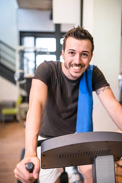 istock cheerful man walking on the gym treadmill 477500432
