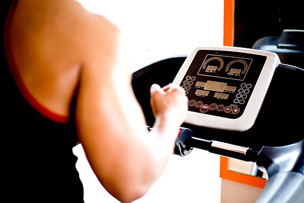 istock Man exercising on a treadmill in a gym 477500984