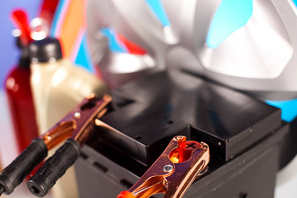istock Car battery with two jumper cables clipped 477500990
