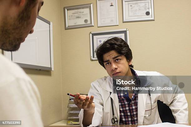 Sad Young Male Doctor Consoling His Pattient Stock Photo - Download Image Now - 20-29 Years, 2015, Adult