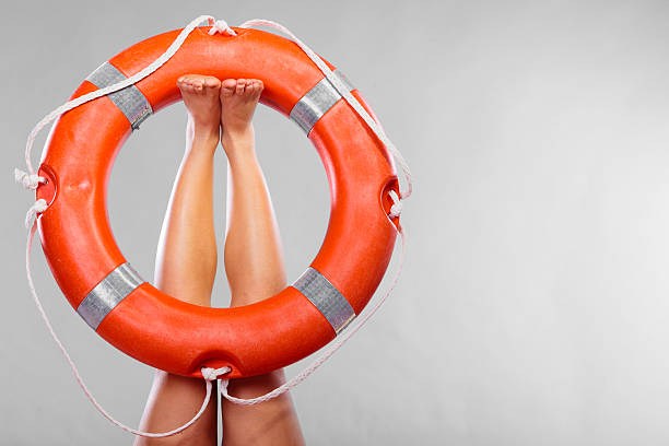 istock Life buoy ring on female legs 477506748