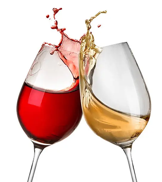 Splashes of wine in two wineglasses isolated on white
