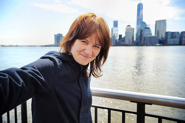 istock Young girl taking selfie with skyscrapers 477511464