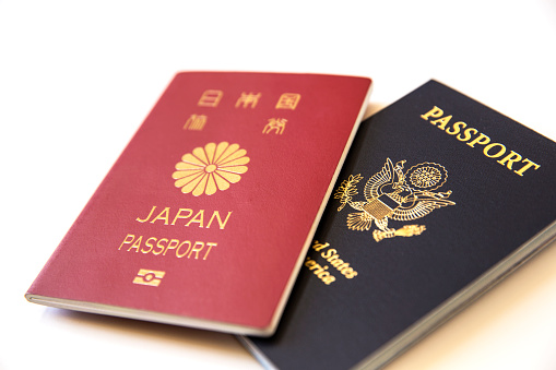 US and Japanese passport on white background