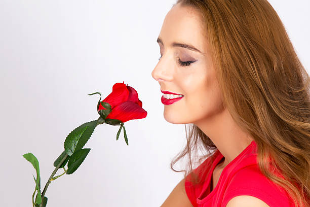 istock Woman smells red rose 477513083