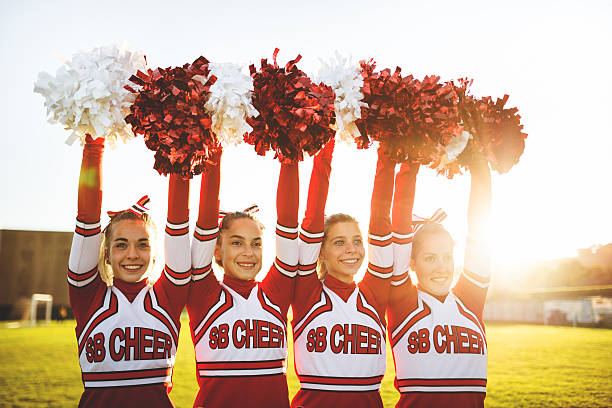istock Happiness cheerleaders posing with pon-pon and arm raised 477513221