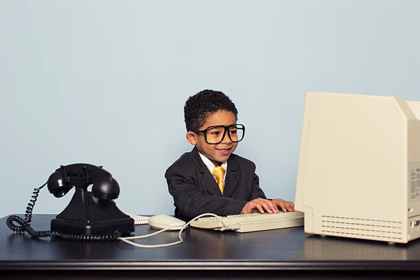 istock Young Business Boy Works at Retro Computer 477513277