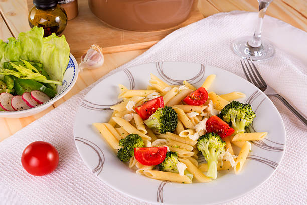 istock Pasta penne with broccoli, tomatoes and mozzarella 477514194