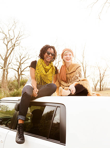 istock Young Women Sitting on a Car 477516187