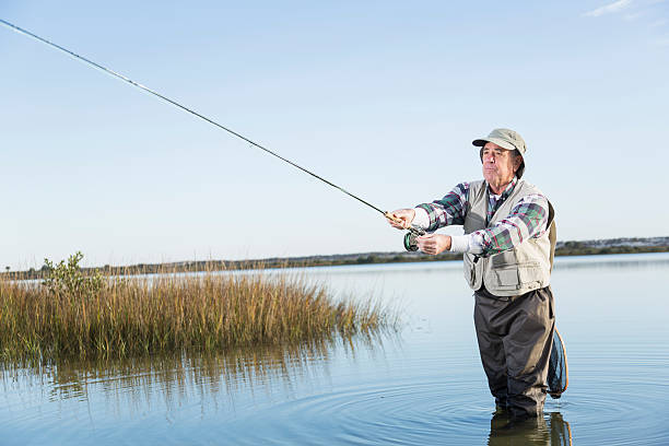 istock Senior man fly fishing 477516279