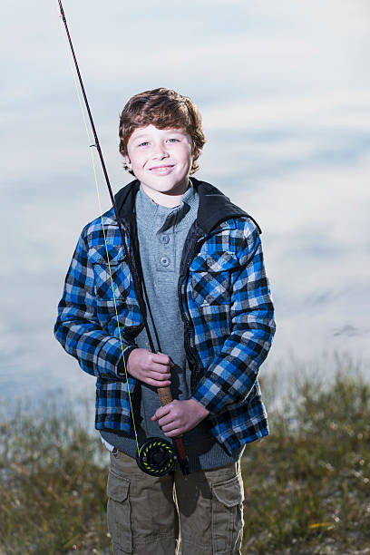 istock Boy with fishing rod 477518055