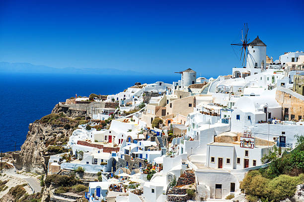 Beautiful Morning view of Oia, Santorini, Greece White Village of Oia windmills, Santorini, Greece. paros stock pictures, royalty-free photos & images