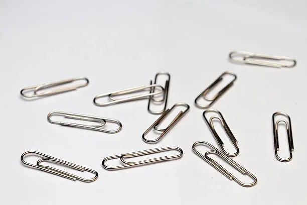 Image of silver paper clip isolated on white background