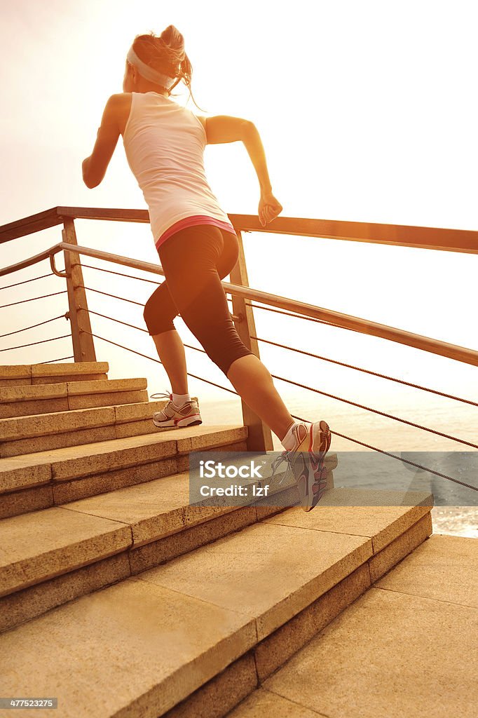 healthy lifestyle asian woman running at stone stairs seaside Active Lifestyle Stock Photo