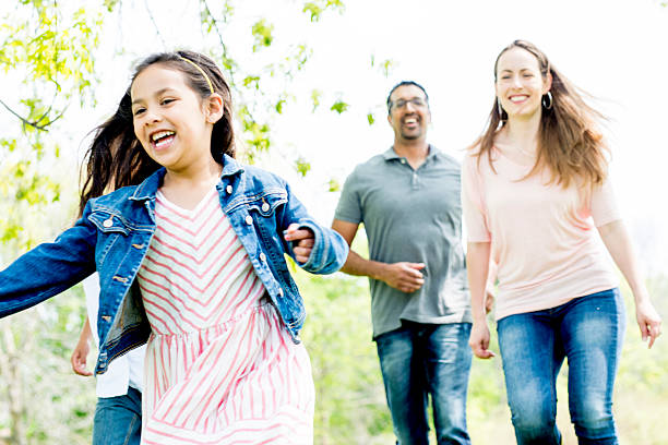 istock Family Running at a Park 477523930
