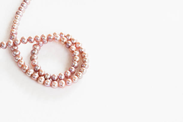istock pink pearls swirl 477524130