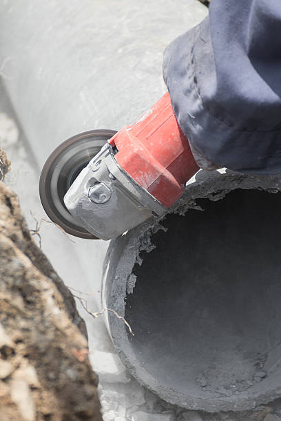 istock Plumbers cutting concrete water pipes 477525050