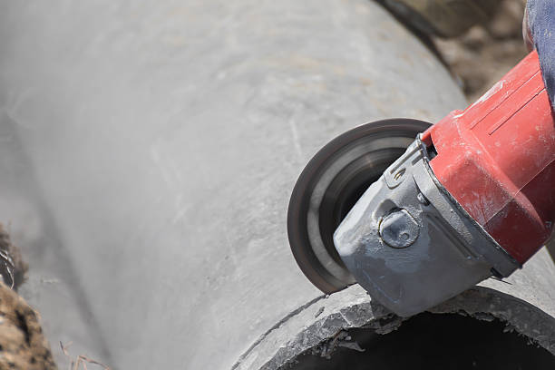 istock Plumbers cutting concrete water pipes 477525184