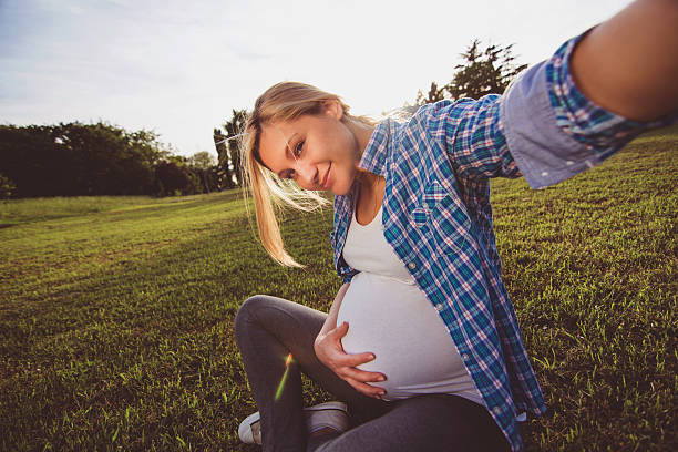 istock Pregnant woman taking selfie 477525202