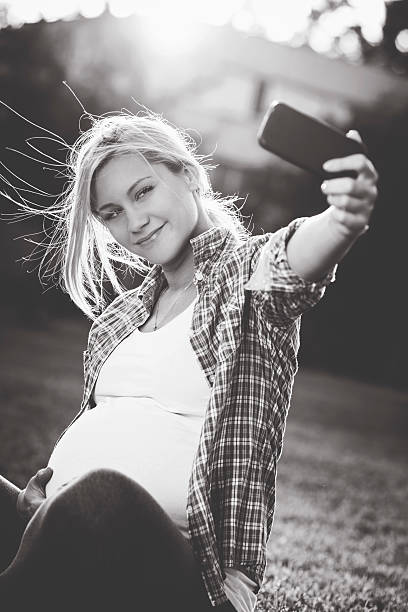 istock Pregnant woman taking selfie 477525208