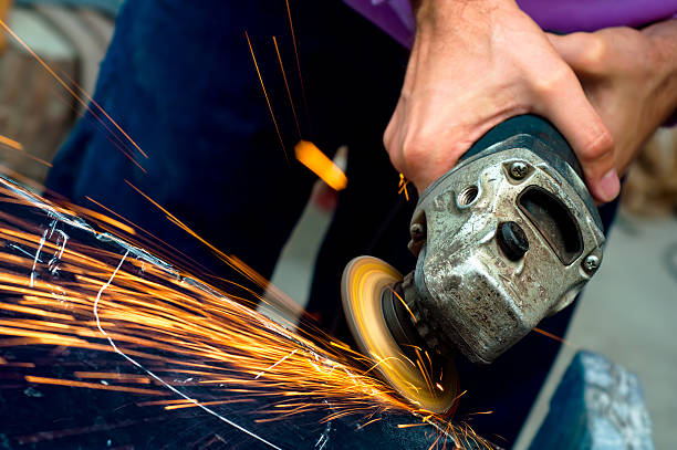 istock Heavy industry worker cutting steel with angle grinder 477525299