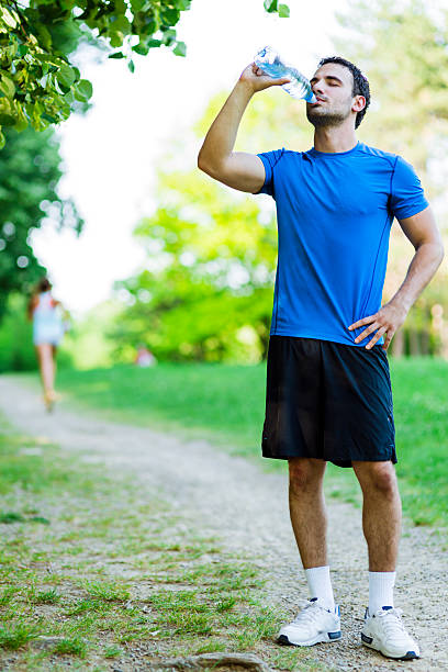 istock Young male athlete drinking water 477525756